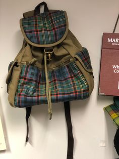 This tartan and canvas rucsac is the perfect accessory for those who love to embrace their Scottish heritage in style. Handcrafted with care, this rucsac is made with your choice of tartan, using heavyweight 100% wool tartan woven in Scotland. With a wide range of colors available, you can choose the canvas that best complements your chosen tartan. Whether you prefer the earthy tones of Olive Green and Sand, or the classic appeal of Black and Navy, we've got you covered. Designed with both funct Green Preppy School Bag, Preppy Green Travel Bag, Casual Plaid School Bag, Preppy Green Bag For Everyday Use, Casual Plaid Travel Bag, Casual School Satchel With Canvas Lining, Casual Satchel With Canvas Lining For School, Plaid Satchel Shoulder Bag For Travel, Casual Cotton Plaid Bags