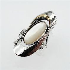 LONG and BEAUTIFUL Mother of pearl ring, inlaid in solid sterling silver decorated with a yellow gold frame, a unisex statement ring, Length: 35 mm / 1.1 in., Width:18 mm / 0.6 in. Available in many other stones. Labeled and stamped 925. This beautiful set will be sent to you in a gift box. Please feel free to contact us for any matter. Metal: Sterling Silver 925 9K Yellow Gold Gemstone: Mother of pearl, Oval 20mm X 10mm Available to be made in many other gemstones, please feel welcome to be cre Sterling Silver Opal Ring, White Stone Ring, Mother Of Pearl Ring, Silver Pearl Ring, Long Ring, Silver Opal Ring, Pearl Gemstone, Beautiful Ring, Art Beautiful