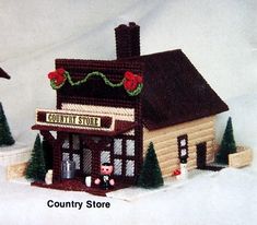 a small town store with christmas decorations on the front and side of it's building