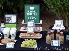 a table topped with drinks and food next to a sign that says drink coffee bar