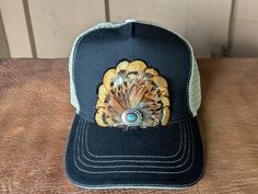 Transform your look with our Golden Trucker Hat. This versatile hat is great for music festivals, outdoor activities, and more. Channel your inner rocker and country music aficionado while staying comfortable and stylish in western fashion. It features a classic chino twill front panel and a soft tea stain mesh back panel. The antique silver Southwestern-inspired Concho with faux turquoise adds a touch of rustic charm. With a velcro closure and a comfort sweatband, it's perfect for all head sizes. Hat Holder, Cloth Tape, Tea Stains, Music Festivals, Felt Hat, Hat Band, Hat Sizes, Rustic Charm, Country Music