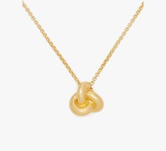 Tie your look together with this polished gold-tone pendant. | Kate Spade Double Knot Pendant, Gold Kate Spade Gold Pendant Necklace, Kate Spade Gold Pendant Jewelry, Kate Spade Gold Elegant Necklace, Kate Spade Gold Jewelry For Formal Occasions, Formal Gold Jewelry By Kate Spade, Chic Gold Kate Spade Jewelry, Elegant Gold Kate Spade Jewelry, Double Knot, Pendant Gold