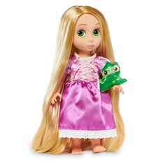 a doll with long blonde hair holding a frog