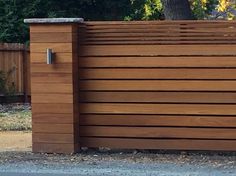 a wooden fence is shown in front of a tree