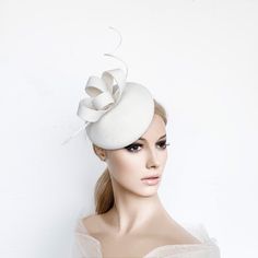 Ivory cocktail hat hand blocked on a button shape wood hat block, made with wool felt and trimmed whith a ostrich spine and a felt bow in Kate Middleton Style. This hat is perfect for winter races, christmas parties, weddings or any special occasion. It is mounted on a elastic . ** MADE TO ORDER (2-5 DAYS) ** DELIVERY TIME (DHL EXPRESS WITH TRACKING NUMBER): 2-4 business days to EEUU, 1-2 to Europe and 3-5 to Australia. Follow this link for more beautiful choices from 'Sophie Young Hats' https:/ White Curved Brim Felt Hat For Parties, White Felt Hat With Curved Brim For Party, Elegant White Hat For Gift, Elegant Fascinator With Pinched Crown For Gift, Elegant Pinched Crown Fascinator Gift, Elegant Cream Headpiece For Gift, Elegant White Costume Hat As Gift, Elegant Felt Cloche Hat, Elegant Fitted Felt Mini Hats