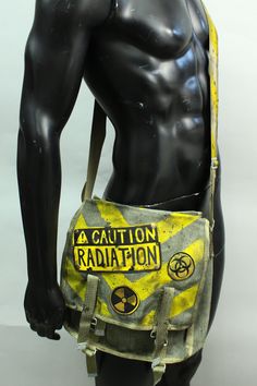 Post Apocalyptic Bag - Radiation Ammo Pouch - Military Canvas Pack - Messenger Bag - Biohazard - Patches - Larp Accessory - Yellow Stripes This listing is for a made to order bag. Please Note: The pack pictured above is representative of the style. Individual purse will vary in appearance. Simple military bag with post-apocalyptic decorations. Hand-painted stripes on the canvas and lettering + a bomb on leather patches sewn on the closure. The last photo is here to show an additional strap optio Apocalyptic Fashion, Military Bag, Estilo Punk, Mein Style, Character Outfits, Post Apocalyptic, Yellow Stripes, Larp, Messenger Bags