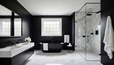 a black and white bathroom with a claw foot tub