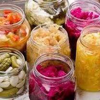 several jars filled with different types of food