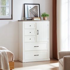 a white cabinet with drawers in a room