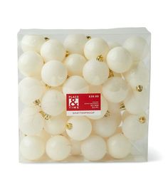 a clear box filled with white and gold christmas bauble ornament balls