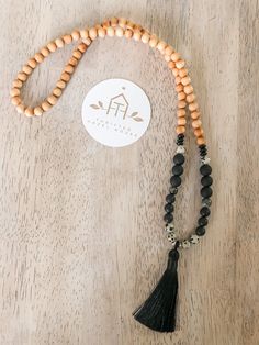 Boho style beaded necklace with large tassel in black Black 8mm Beads Beach Jewelry, Black Beach Jewelry With 8mm Beads, Black Beaded Jewelry For Beach, 8mm Beads, Elegant Black Necklace For The Beach, Elegant Black Necklace For Beach, Bohemian Onyx Beaded Necklace With Black Beads, Bohemian Black Onyx Beaded Necklace, Black Spiritual Necklace For Beach, Bohemian Onyx Necklace With Black Beads