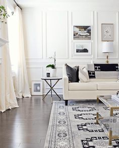 a living room filled with furniture and white walls