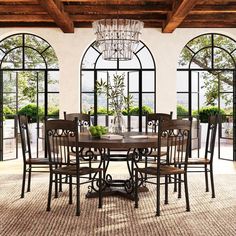 a dining room table with chairs and a chandelier