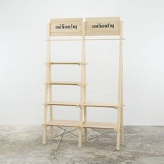 two bookshelves sitting on top of each other in front of a white wall