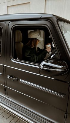 a woman sitting in the driver's seat of a truck