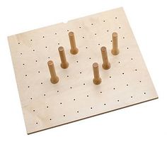 a wooden peg board with four pegs on it