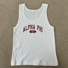 a white tank top with the word, alpha phi printed on it's chest