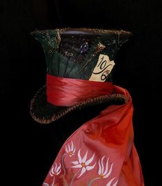 a hat with a red ribbon around it