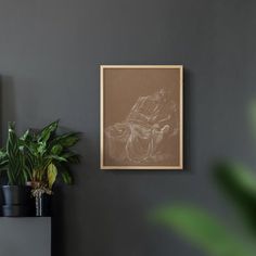 there is a plant in the corner next to a painting on the wall and a potted plant