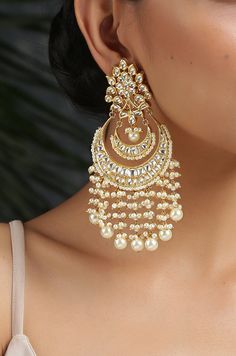 This beautifully handcrafted earrings is set in silver and copper alloy and plated with 22k gold. DETAILS Length - 7.5 cm Closure - Push Back STYLE TIP We love teaming this with classy chiffon sarees or zari silk sarees. Also looks best when worn with your royal whites, off whites and gold. We recommend styling with pastel solids or floral dresses in peachy pink, pistachio green and pastel blue too. Perfect for them Red weddings or banarasi sarees. This is a perfect solution to your pastel weddi Earrings For Saree, Chandbali Earrings Gold, Aesthetic Saree, Gold Indian Jewelry, Desi Jewellery, Kundan Chandbali, Red Weddings, Desi Jewelry, Aesthetic Jewellery