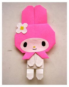 a paper doll made to look like a girl with flowers on her head and pink hair