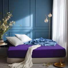 a bed with blue sheets and white pillows