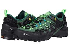 a pair of green and black hiking shoes