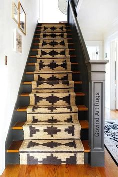 the stairs are decorated with rugs on them