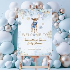 a baby shower sign is displayed in front of balloons and snowflakes on a blue background