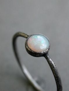 Opal stacking wedding ring or engagement ring in oxidized sterling silver or matte finish.  October birthstone ring  the band is made with 16 gauge sterling silver wire and tapered towards the stone. please add ring size in the notes to seller section during checkout.  rings are handmade by me in my studio in austin, texas. the original set was made in february 2011 for some friends of friends. and, now, finallyi'm thrilled to offer them available for order here.  NOTEplease be certain of your r Engagement Ring Stacking, Stacked Engagement Ring, Opal Stacking Ring, October Birthstone Ring, October Birthstone Rings, Resize Ring, Alternative Bridal, Ring Stacking, Modern Ring