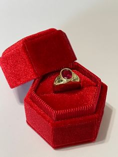 Amazing vintage 14k yellow gold created ruby ring, circa 1960s! The created red ruby weighs an estimated 1.21 carats, is oval cut, and is a stunning deep red. The setting contains a classic design with a high polish finish. Classic statement piece of fine retro jewelry showcasing a stunning created ruby, circa 1960s! ERA - Circa 1960s, Retro METAL / MATERIAL - 14k yellow gold, 1 created ruby (estimated 1.21 carats) [Synthetic ruby contains essentially the same chemical composition & properti Formal Ruby Signet Ring With Bezel Setting, Ruby Signet Ring With Bezel Setting For Formal Occasions, Classic Red Signet Ring Stamped 14k, Formal Red Ruby Ring Stamped 14k, Oval Ruby Ring For Anniversary Stamped 14k, Oval Ruby Ring Stamped 14k For Anniversary, Classic Red Signet Ring For Anniversary, Classic Yellow Gold Ruby Signet Ring, 14k Gold Red Signet Ring For Anniversary