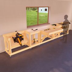 a table with tools on it in front of a window and a person looking out the window