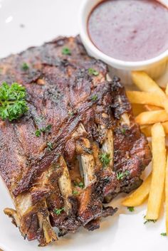 a steak and french fries on a white plate