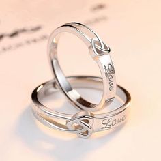 two wedding rings with names engraved on them