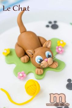 a close up of a cake with a cat on it