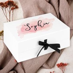 a white box with the word sopha on it and some flowers around it