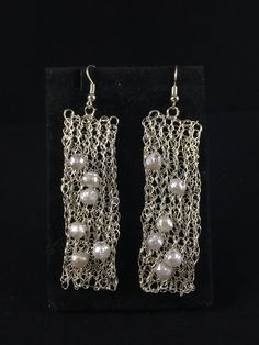 "These are hand crocheted from stainless steel wire. Crocheted in are pearls. The earrings drop 2 1/2\" from the earring wire, which is nickel free! These earrings are super light and comfy to wear" Metal Beaded Drop Earrings With Pearl, Handmade Pearl Beaded Dangle Earrings, Handmade White Pearl Earrings With Metal, Handmade White Metal Pearl Earrings, Handmade Pearl Drop Chandelier Earrings, Metal Dangle Beaded Earrings With Pearl Drop, Handmade Silver Pearl Beaded Earrings, Metal Beaded Earrings With Pearl Drop As Gift, Pearl Drop Beaded Earrings As A Gift