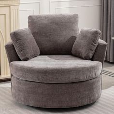 a large round chair sitting on top of a carpeted floor next to a fire place