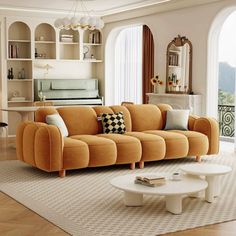 a living room with an orange couch and white coffee table in front of a large window