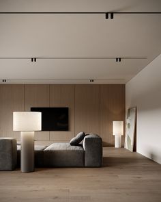 a living room with a couch, lamp and television on the wall in it's corner