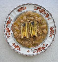 a white plate topped with beans and meat