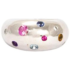 This ring holds Sapphires, Diamond, Rubies and Citrine. The multi coloured stones in this chunky 18ct white gold band are stunning. The smooth rounded band is paired perfectly with the round cut stones of all sizes. Hallmarked London 2015. Ring Size: M or 6 1/2 Band Width: 11mm White Gold Round Multi-stone Gemstones, Modern Multicolored Multi-stone Gemstones, Silver Multi-stone Round Cut Gemstones, Silver Platinum Multi-stone Rings, Modern Multi-stone Gemstones For Anniversary, Platinum Multi-stone Silver Rings, Modern Multi-stone Silver Gemstones, Modern Silver Multi-stone Rings, Simple Vintage Rings