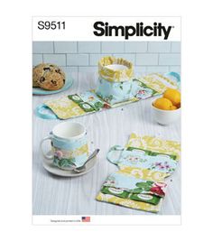 a table with plates, cups and saucers on it that has the words simpl city printed on them