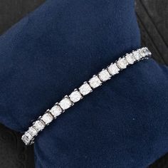 Your classic and timeless tennis bracelet with larger diamonds - perfect scale for daily wear, both day and evening! Bold enough to wear on its own, but will play nice with others as well. Super bright diamonds! 14kt white gold Will fit up to a 6.25" wrist + an addition .75" extension that can be added at buyers request Diamonds are estimated to be G/H colors & SI/I1 clarities. GIA Standards Please see qualitative report for more information. Video Below White Platinum Diamond Bracelet With Accents, Platinum Tennis Bracelet In Diamond White, Diamond White Brilliant Cut Platinum Tennis Bracelet, Classic Diamond Tennis Bracelet With Accents, Classic Diamond White Tennis Bracelet, Platinum Tennis Bracelet With Brilliant Cut Diamond White, Classic Tennis Bracelet In Diamond White With Diamond Cut, Platinum Brilliant Cut Diamond White Tennis Bracelet, Classic White Round Cut Diamond Bracelet