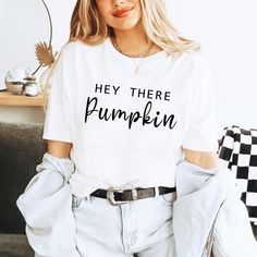 Hey There Pumpkin Shirt - Cute Fall Season Tee, Thanksgiving and Halloween Outfit, Gift for Her Celebrate the cozy vibes of autumn with this adorable "Hey There Pumpkin" shirt. Perfect for the fall season, this cute and stylish tee is ideal for Thanksgiving, Halloween, or any autumn day. Whether you're sipping on pumpkin spice lattes or enjoying a fall festival, this shirt is a must-have for your seasonal wardrobe. It also makes a sweet gift for her, whether she's a fall enthusiast or just loves a cute and comfy tee. Fall Season Shirt, Pumpkin Shirt, Thanksgiving Outfit 👉HOW TO ORDER👈 1️⃣ Please review all the information provided before placing an order 2️⃣ Select the shirt type and size using the drop down menu. 3️⃣ Select the color of the shirt using the following drop down menu. 4️⃣ Halloween Text Print Relaxed Fit Top, Halloween Relaxed Fit Top With Text Print, Trendy Halloween Tops With Text Print, Relaxed Fit Halloween Top With Text Print, Trendy Fall Shirt With Text Print, Funny Print Relaxed Fit Shirt For Fall, Relaxed Fit Shirt With Funny Print For Fall, Halloween Cotton Slogan Top, Halloween Cotton Top With Slogan