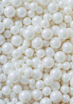 some white pearls are piled up together