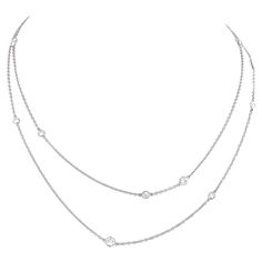 Circa 1980s, Platinum, by Elsa Peretti for Tiffany & Co. New York. This Diamonds by the Yard necklace is a fine example of Poretti's iconic Tiffany design. Uncommon in platinum, it is set with 3.0 carats of F-G colored, VS clarity diamonds (12 stones). Worn long, doubled, or as part of a multiples look, it stands out as exceptional fashion Tiffany style. Excellent condition. Quote: "I wanted to make diamonds a little more casual. -Elsa Peretti" Remark: "Only Tiffany can be this effortlessly clas Tiffany Smile Diamond Necklace, Tiffany Diamond Necklace Return To Tiffany, Tiffany And Co Necklace Hardwear, Elsa Peretti Necklace, Diamond Pendant Tiffany & Co., Tiffany Elsa Peretti Necklace, 12 Stones, Elsa Peretti, Tiffany Style