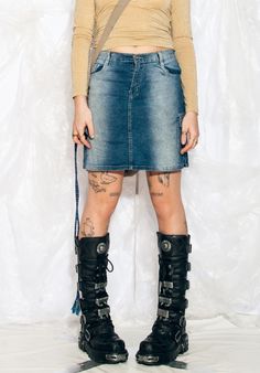 "This Y2K vintage cargo skirt is the ultimate throwback to your raver days. Channel your inner party animal with this mini in stonewashed blue shades. Features: - seven pockets - zip closure Every item we manage is cleaned and, when necessary, repaired, ensuring it arrives to you in top condition. Our model, Szedi is 170 cm / 66.3\" tall and she's a size L. Size: L / US 8 / UK 12 / IT 44 Measurements:  waist (seam to seam): 40 cm / 15.6\" length: 44 cm / 17.2\"" Grunge Mini Skirt With Pockets For Streetwear, Punk Denim Skirt With Pockets For Streetwear, Grunge Mini Denim Skirt With Pockets, Punk Denim Skirt With Pockets, Grunge Denim Skirt With Pockets For Streetwear, Grunge Streetwear Denim Skirt With Pockets, Grunge Mini Denim Skirt For Streetwear, Y2k Mini Skirt For Streetwear, Punk High Waist Denim Skirt For Streetwear