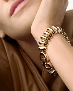 A gorgeously fluid bold bracelet that boasts a ribbed texture through a unique caterpillar construction. Vintage-inspired foldover closure, finished in high-polish gold. Using the foldover closure: Look for the JENNY BIRD logo on the flat bar. On one side, you’ll see a hinge, on the other side, you’ll see a tab. Gently pull the tab upward to open. To close, thread the tab closure through the opening, and press firmly to close. You will hear it click into place. Details: Gold tone dipped brass. W Caterpillar Construction, Jenny Bird Jewelry, Custom Bangle, Award Winning Jewelry, Bird Logo, Jenny Bird, Caged Sandals, Ribbed Texture, Bracelet Gold