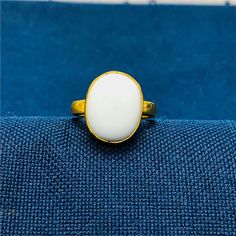 "White Coral 5.25 carat Gold Plated Ring Handcrafted Indian jewelry. Ring is in Gold Plated and finished with Rhodium EXCELLENT GIFT: for birthday, anniversary, holidays, stocking stuffers, graduation, Christmas, Valentine's Day, Mother's Day, Thank You or simply \"Thinking of You ALL RING SIZES AVAILABLE: We have our own manufacturing unit. We can deliver all custom ring sizes on request. CONTACT US: If you have any question, please post into \"Customer Questions & Answers\" below the \"Product specifications\".  Product colour may slightly vary due to photographic lighting sources or your monitor settings. Top Quality Craftsmanship Exceptional Styling ENTER OUR SHOP HERE for more fabulous jewelry :  https://www.etsy.com/in-en/shop/JwellsFarms?ref=seller-platform-mcnav" Gift White Opal Gemstone Ring, Classic White Cabochon Opal Ring, White Hallmarked Opal Ring Fine Jewelry, Classic White Opal Ring, Classic Hallmarked White Opal Ring, White Moonstone Ring For Promise, White Opal Ring Gift, Opal Ring With Bezel Setting Gift, White Cabochon Moonstone Ring In Fine Jewelry Style